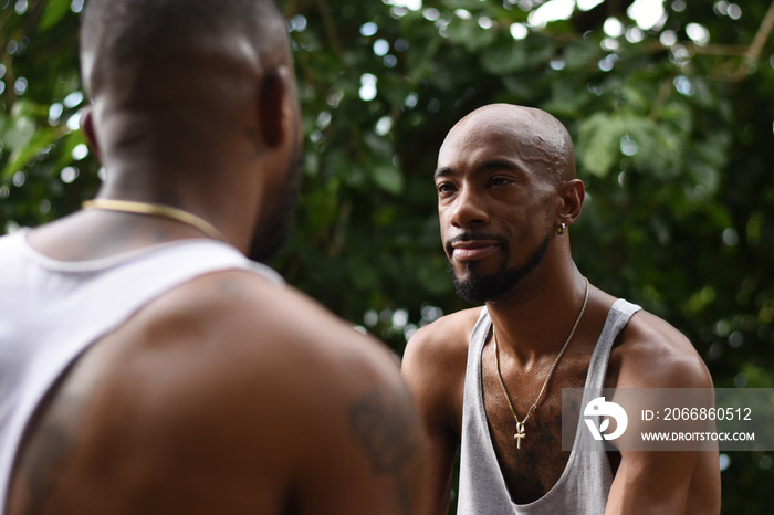 USA, Louisiana, Gay couple talking in forest