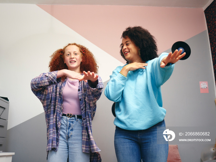 Mother and daughter  dancing in room