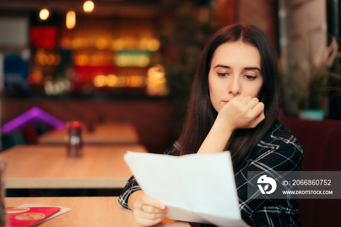 Woman Reading Documents in a Coffee Shop