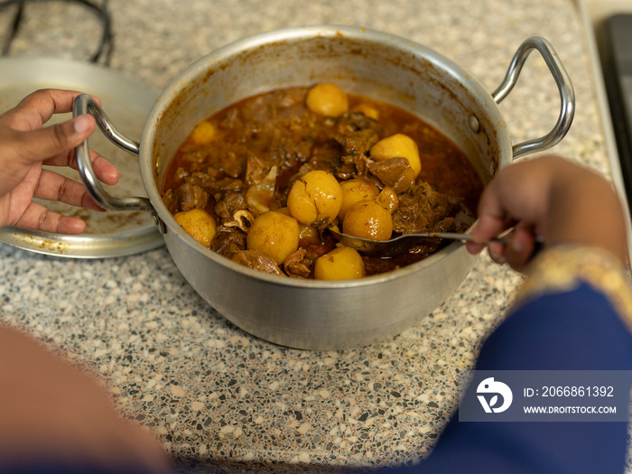 Woman preparing meal with meat form Ramadan at home