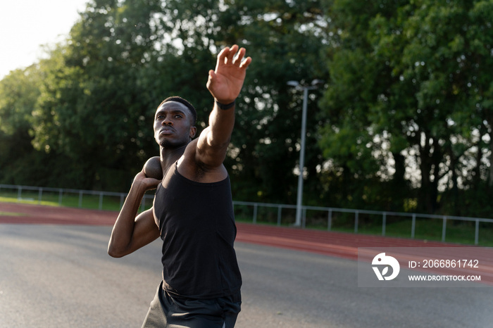 Portrait of shot putter preparing to throw