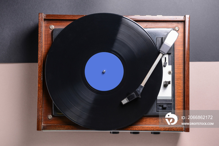 Record player with vinyl disc on table