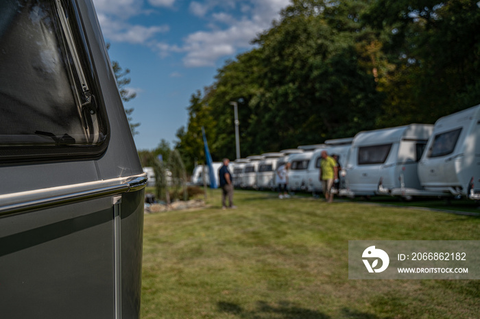 Line of Brand New Camper Vans Motorhomes Awaiting Clients on Dealership Sales Lot. Recreational Vehicles Selling. Caravanning Industry.