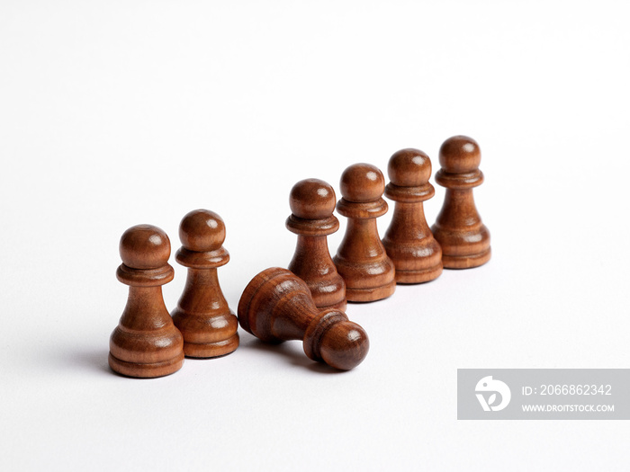 Row of chess pawns with one pawn fell in line. Weak link in the team or employee burnout and exhaustion