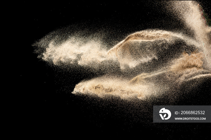 Brown sand explosion isolated on black background. Freeze motion of sandy dust splash.Sand texture concept.