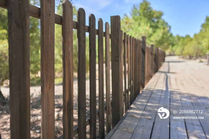 wooden fence on a wooden footbridge on a greenway