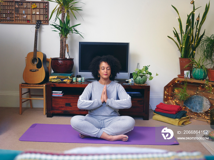 Woman practicing yoga at home