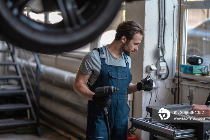 Automotive technician preparing for work in his workshop