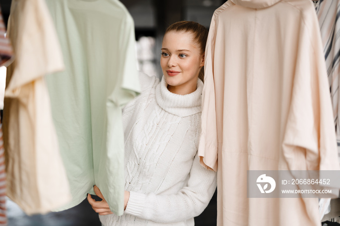 Young blonde white woman choosing clothes