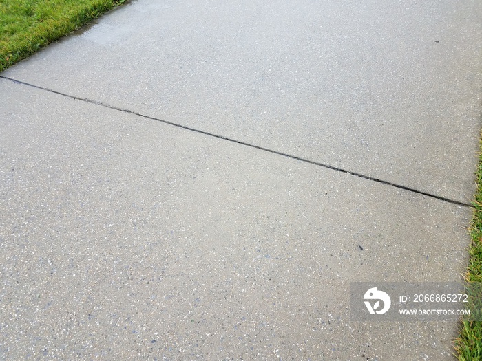 wet gray cement sidewalk or path with line