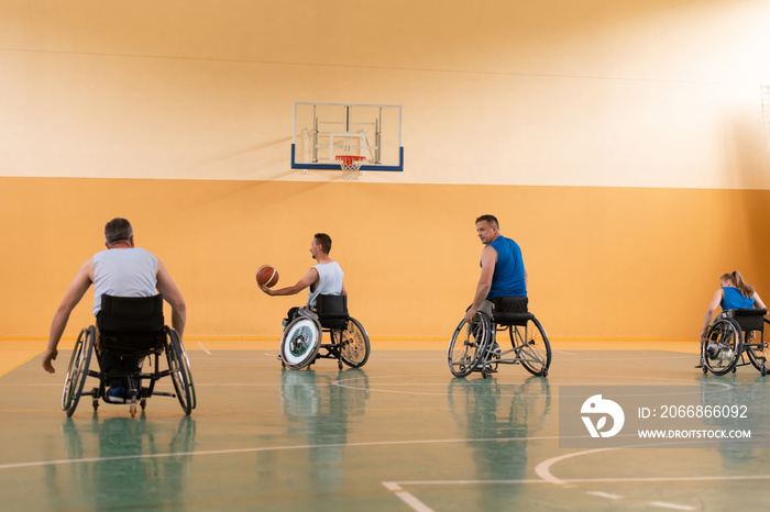 disabled war veterans in action while playing basketball on a basketball court with professional sports equipment for the disabled