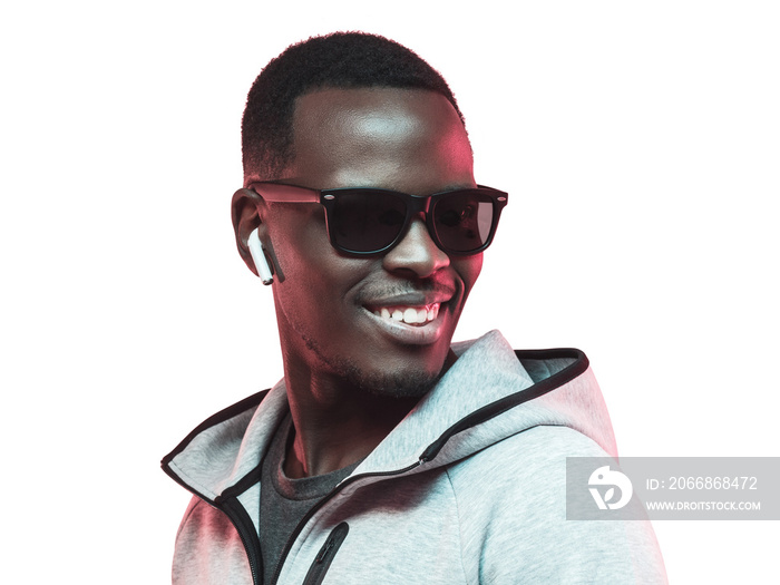 Portrait of young african american man listening music with earphones