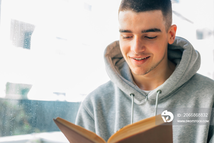 teenage boy reading a textbook