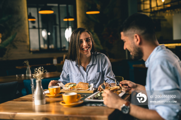 A happy young couple on a date at a fancy restaurant