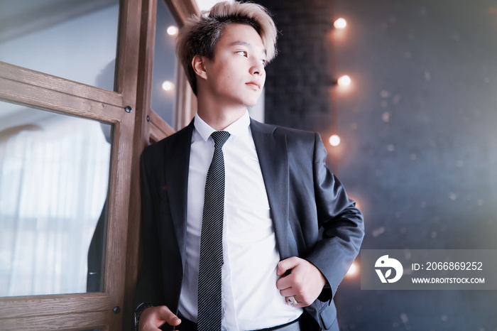 Young Asian businessman in white shirt and tie