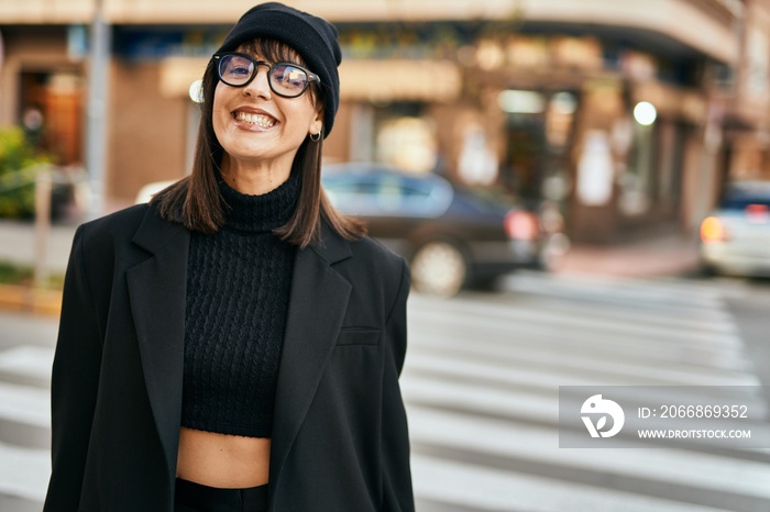 Young hispanic woman smiling happy standing at the city.