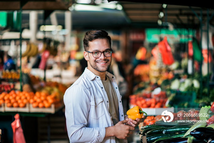 Portrait of a casual young man shopping at local market.