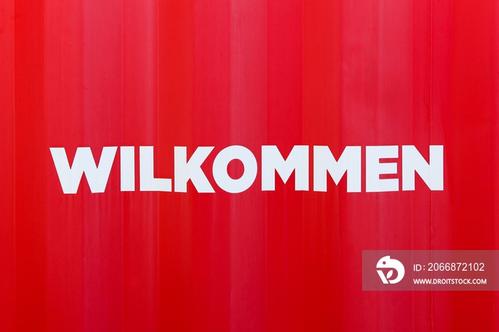 Welcome sign on a container called wilkommen in german language