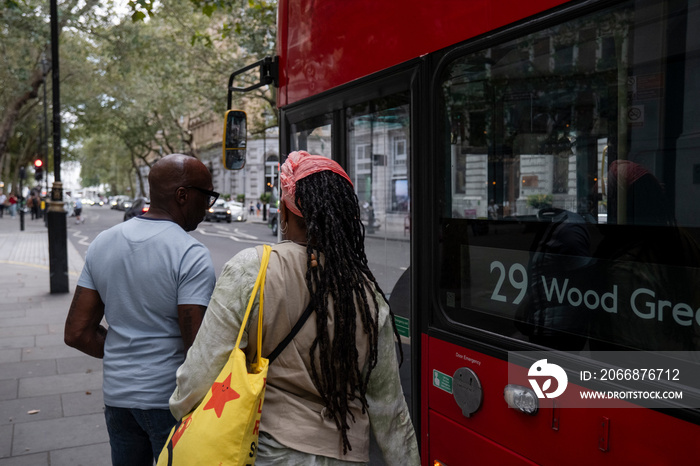 UK, London, Mature couple getting on bus