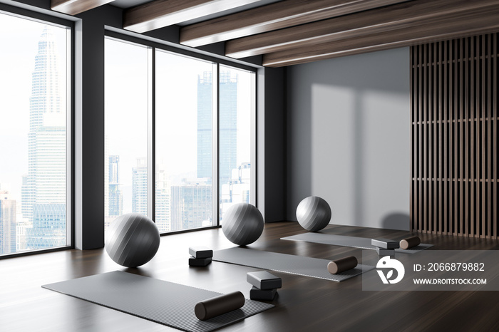 Stylish fitness class interior with sport equipment and panoramic window