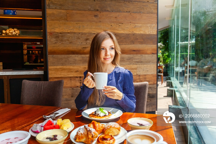 Attractive woman on brunch in hotel buffet restaurant