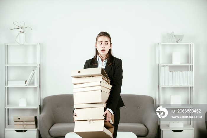 Sadness depressed businesswoman holding many folders with the documents, frustration secretary girl, stressed employee working overtime with too much work, office problem at workspace.