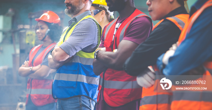 Arms crossed. Professional team working at workplace. Unity and teamwork concept. Portrait engineer factory manager worker and mechanic team together in factory workplace