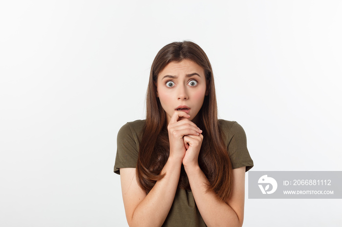 Close-up portrait of surprised beautiful girl holding her head in amazement and open-mouthed. Over white background