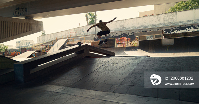 Energetic skater performing trick during freestyle session at skate park.