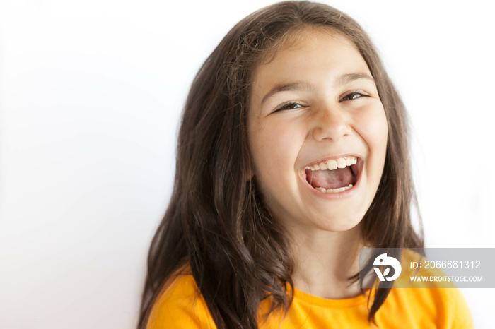Portrait of happy smiling kid girl in yellow T-shirt isolated on white background