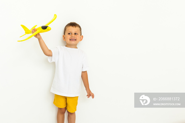 happy child toddler playing with yellow toy airplane