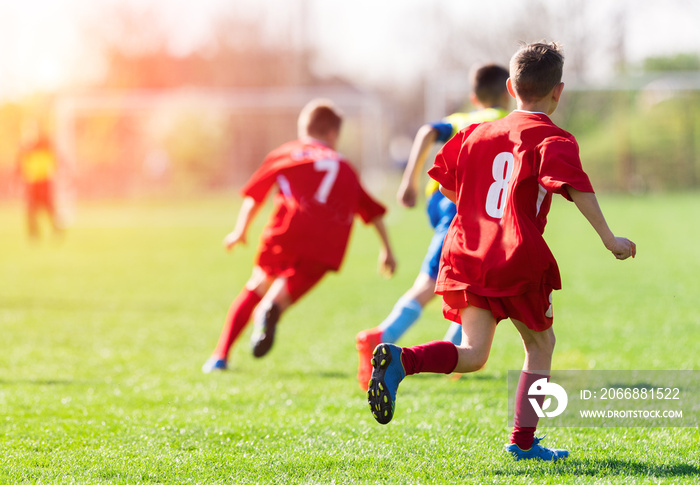 Kids soccer football - children players match on soccer field