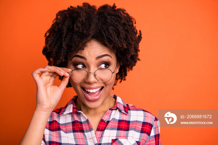 Close-up portrait of her she nice cute attractive cheerful cheery positive optimistic wavy-haired lady nerd wearing checked shirt touching glasses good idea isolated on bright vivid shine orange