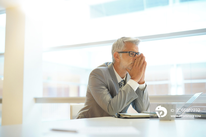 Stressed out businessman sitting at desk