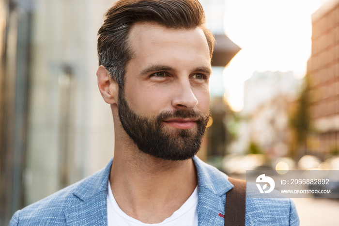 Attractive young bearded man walking outdoors