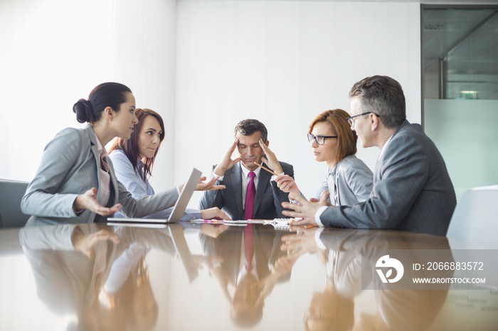 Businesspeople arguing in meeting