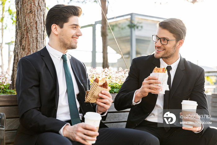 Two attractive young businessmen wearing suits