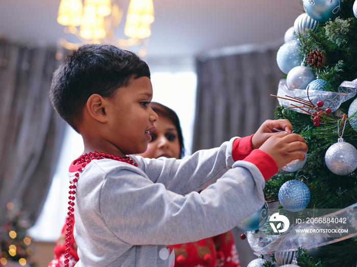 Mother and son decorating Christmas tree