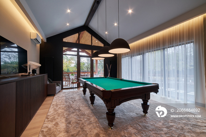 modern billiard room with a beautiful table and large windows