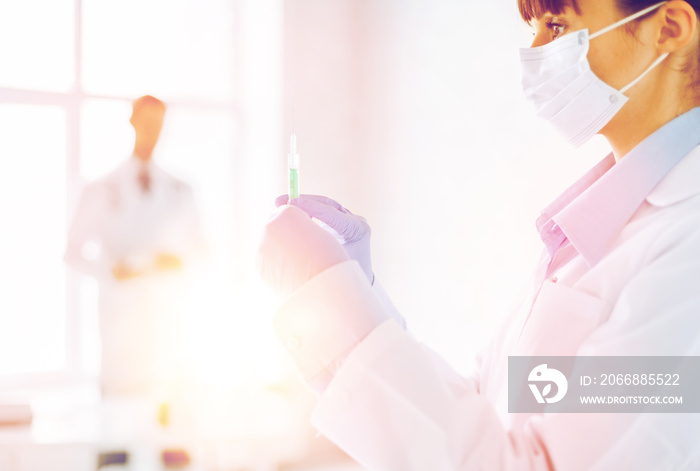 female doctor holding syringe with injection