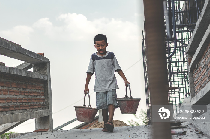 Children working at construction site for world day against child labour concept: