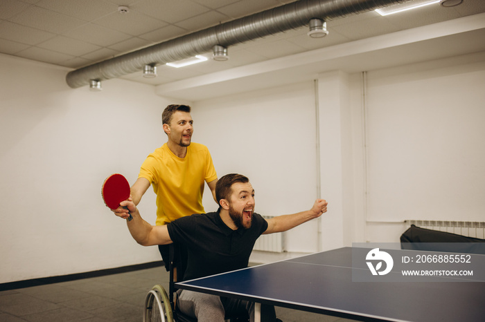 Table tennis training of an athlete in a wheelchair. Sports for the disabled.