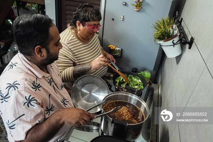 Plus sized parents making a healthy meal for the family