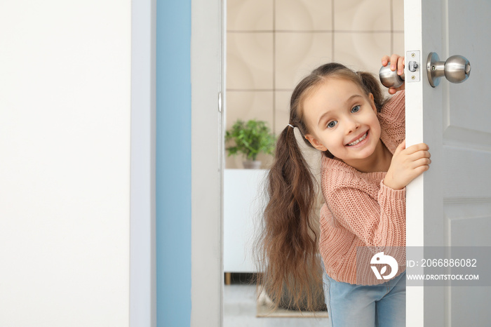 Cute little girl looking out the door