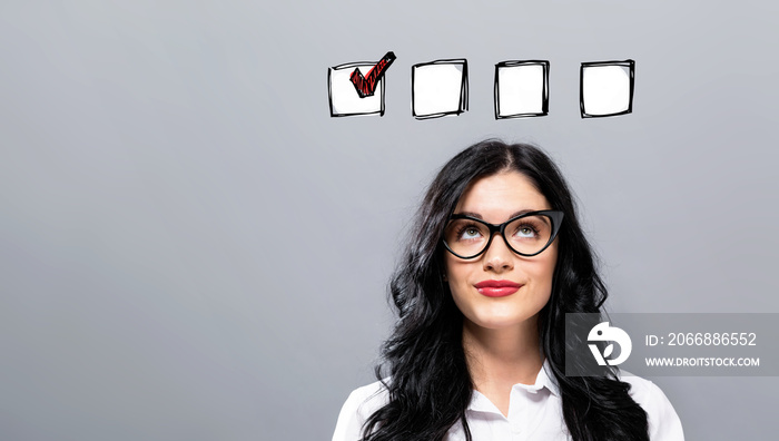 Checklist with young businesswoman in a thoughtful face