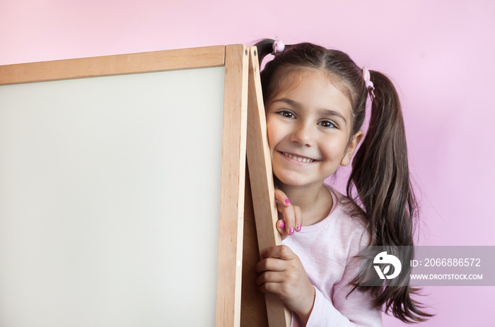 Back to school. Cute little child girl with blackboard.