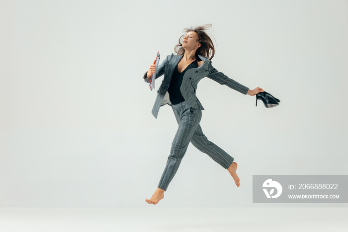 Happy business woman dancing and smiling in motion isolated over white studio background. Human emotions concept. The businesswoman, office, success, professional, , happiness, expression concepts