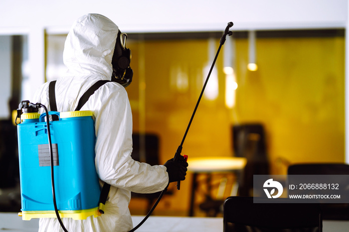 Disinfecting of office to prevent COVID-19, Man in protective hazmat suit with  with spray chemicals to preventing the spread of coronavirus, pandemic in quarantine city. Cleaning concept.