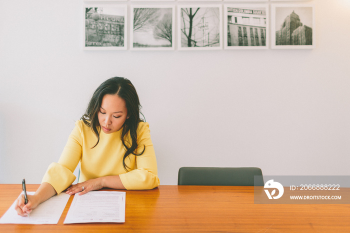 a professional woman sign a contract