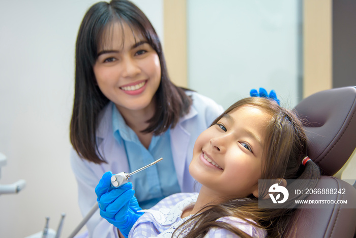 A little cute girl having teeth examined by dentist in dental clinic, teeth check-up and Healthy teeth concept